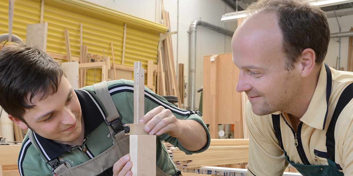 Mensch, Mann, Lehrling, Azubi, Meister, Chef, Auszubildender, zeigen, Fenster, Einbau, Einbau von genormten Baufertigteilen, Handwerk, Fensterrahmen, Rahmen, Holz, Maschine, Werkstatt, anfertigen, einbauen, Glas, Glaser, Fensterbau, Glasfassadenbau, Verglasung, Glasbau, Fensterbauer, messen, ausmessen, abmessen, Schreiner, Tischler 14226
