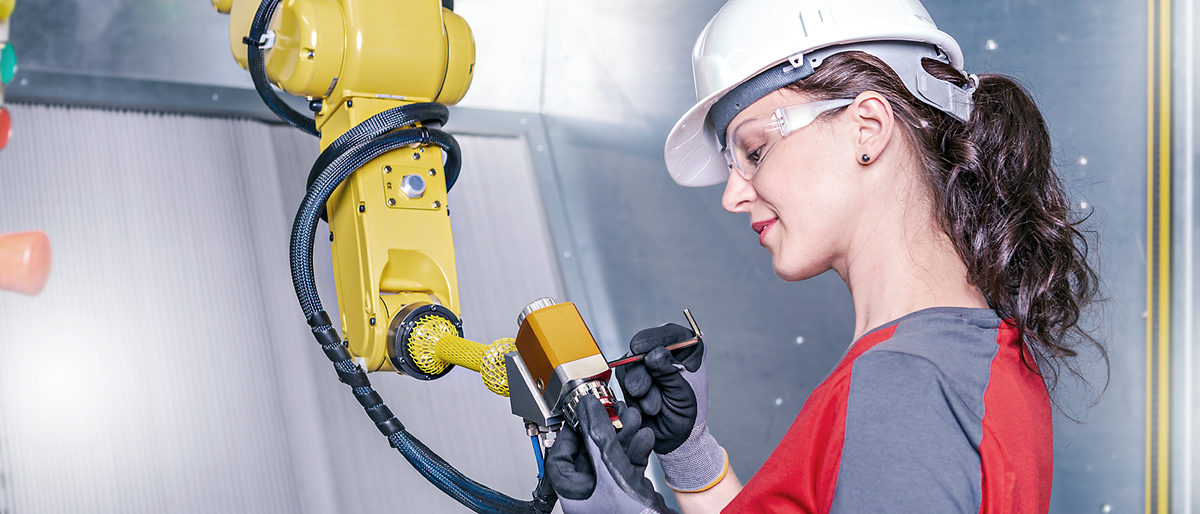 A young female technician while machine constructing in a manufacturing plant Schlagwort(e): automation, checking, construction, consultant, contractor, control, digital, engineer, engineering, engineers, equipment, factory, female, germany, hardhat, industrial, industry, machine, machine constructing, machinery, maintenance, manufacture, manufacturing, manufacturing plant, mechanic, mechanical, metal, occupation, person, planning, plans, plant, production, protective, robot, robotic, robotic arm, safety, service, steel, support, technician, technology, woman, work, worker, working, automation, checking, construction, consultant, contractor, control, digital, engineer, engineering, engineers, equipment, factory, female, germany, hardhat, industrial, industry, machine, machine constructing, machinery, maintenance, manufacture, manufacturing, manufacturing plant, mechanic, mechanical, metal, occupation, person, planning, plans, plant, production, protective, robot, robotic, robotic arm, safety, service, steel, support, technician, technology, woman, work, worker, working, cobot, coboter, Messe, Online, Online-Messe, Kollege, Roboter
